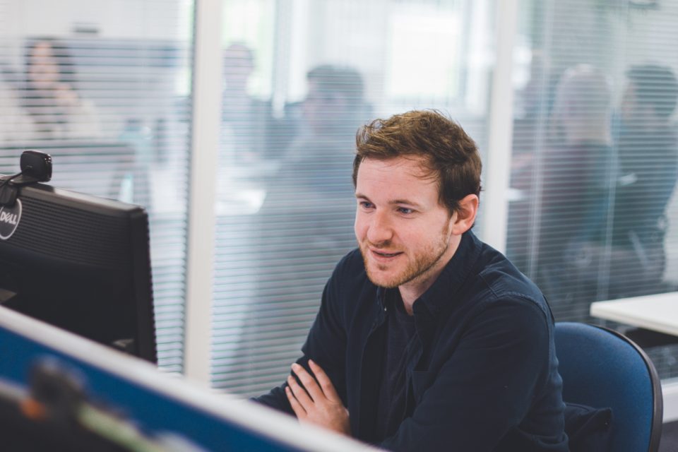 team member looking at screen