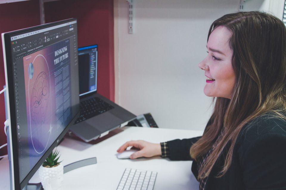 smiling female employee working on design